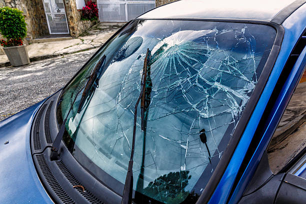 Car Accident. Smashed windshield with head. Driver using no seat belt.