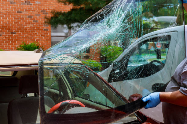 In aftermath an accident near my home, automobile service special workers replaced windscreen