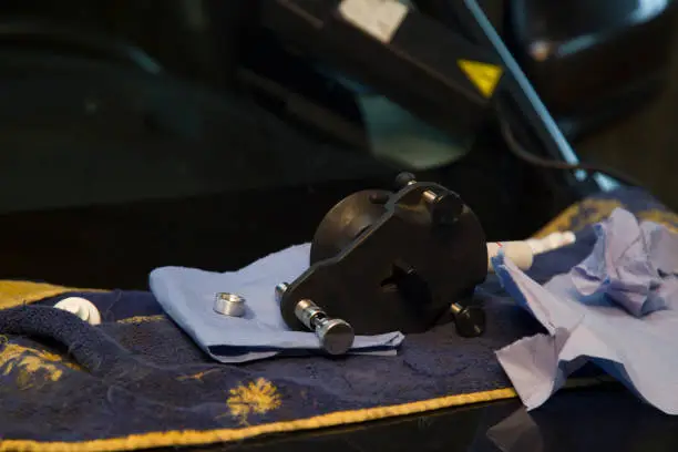 Tools and cloth on car hood after windshield removal.