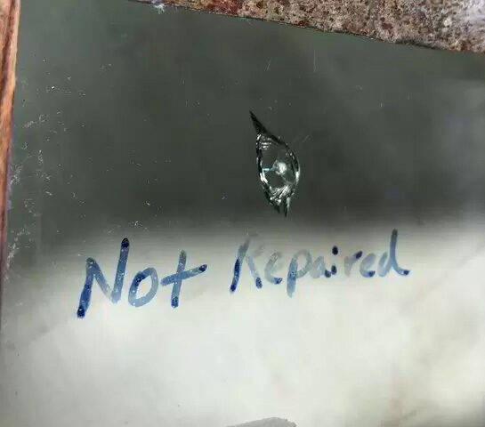 closeup of a chip with "not repaired" written below